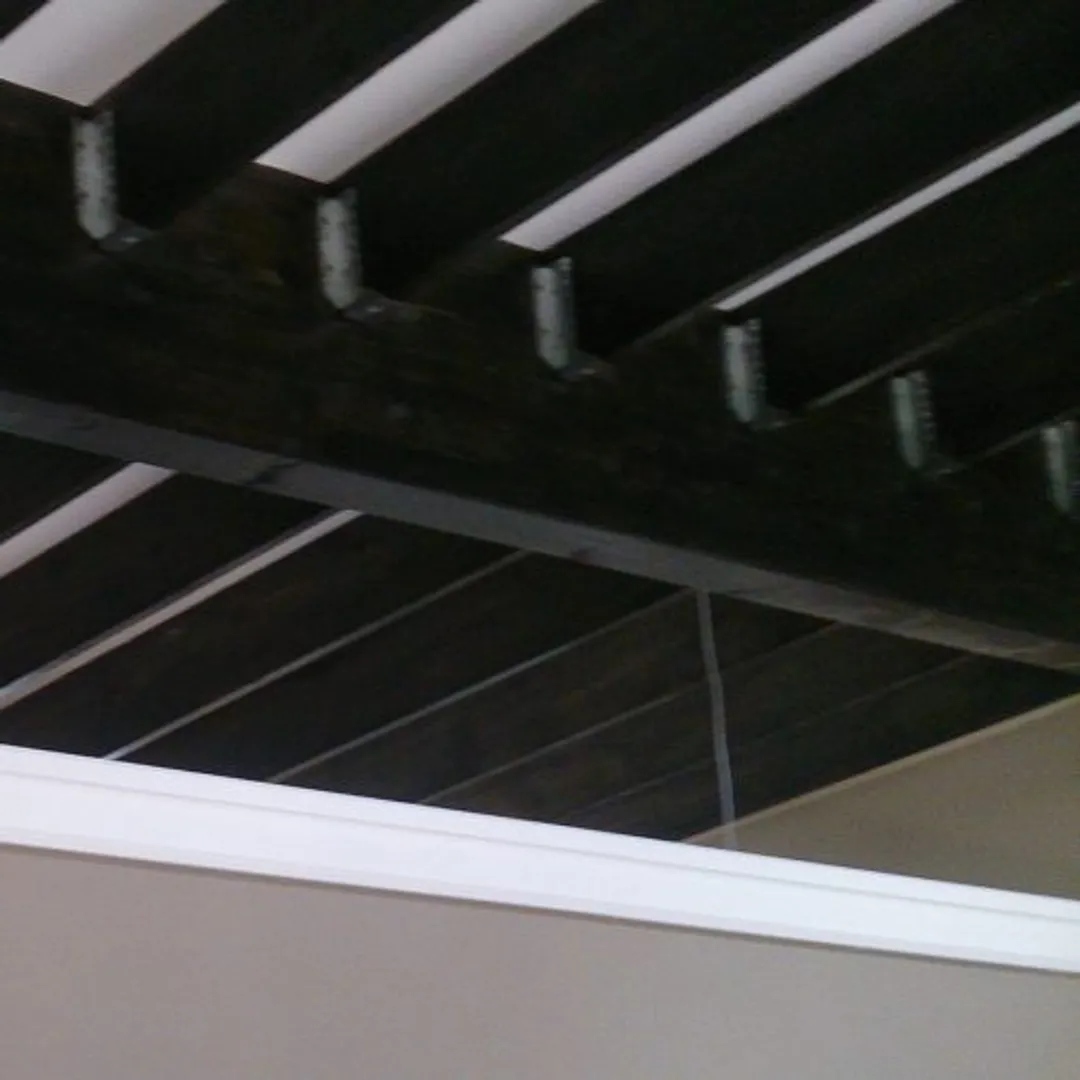 Cornics near exposed ceiling beams